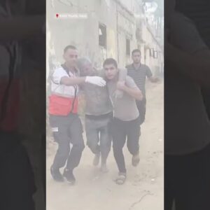 Gaza residents carry children out of a building into ambulances after Israeli airstrikes
