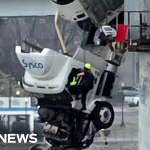 Dramatic rescue as truck dangles from bridge